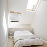 Интерьер белой спальни в мансардном помещении