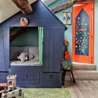 Игрушечный домик в комнате мальчика дошкольного возраста